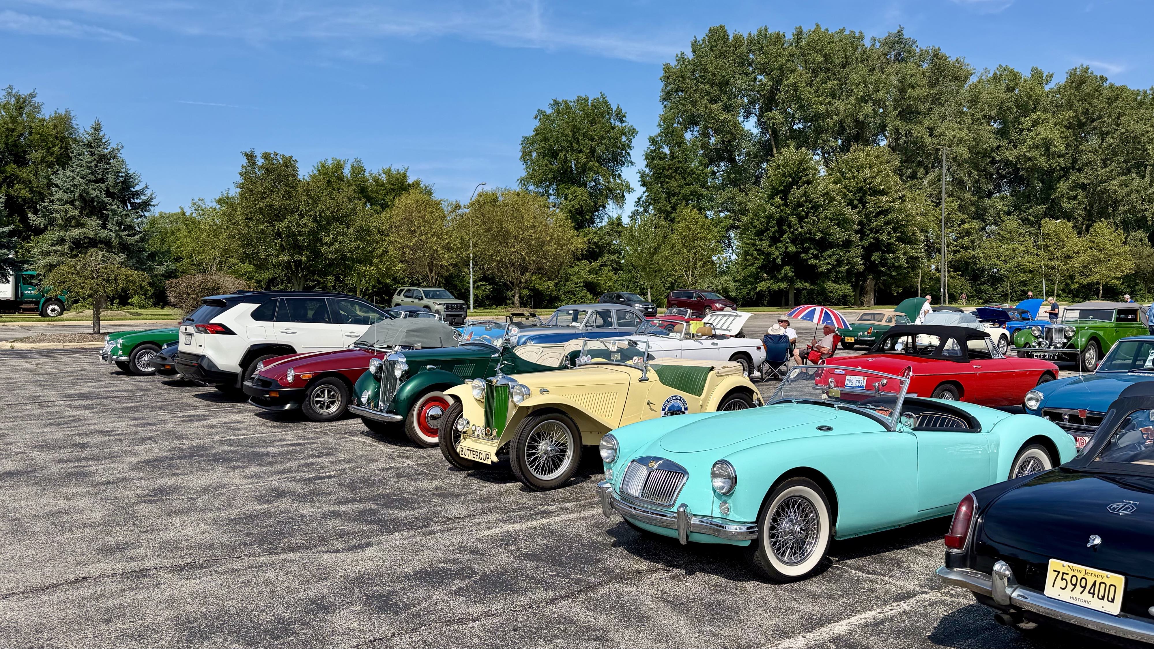 Photograph of a parking lot filled with brightly colored MG sports cars at MG International 2026 in Sandusky Ohio.